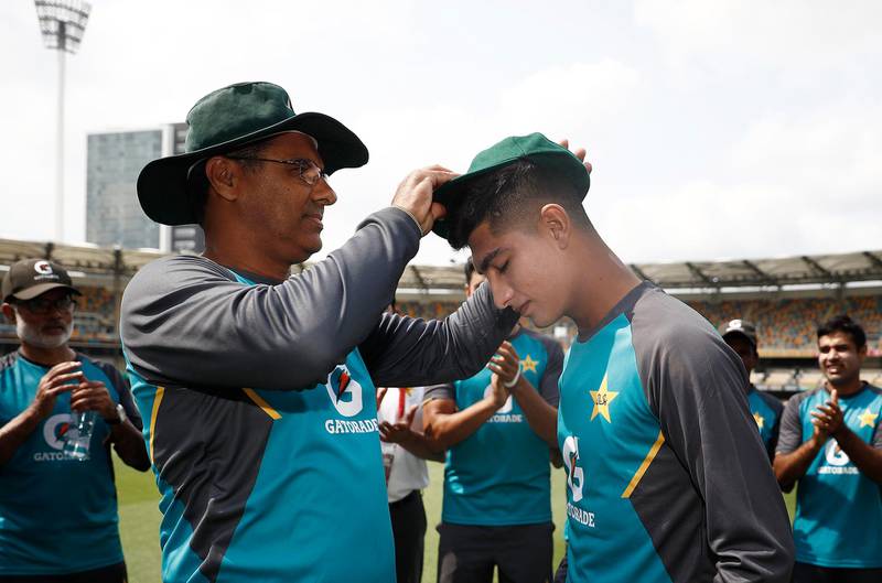 Pakistan's Naseem Shah is presented with his first Test cap by Waqar Younis ahead of his debut against Australia at the Gabba. Getty