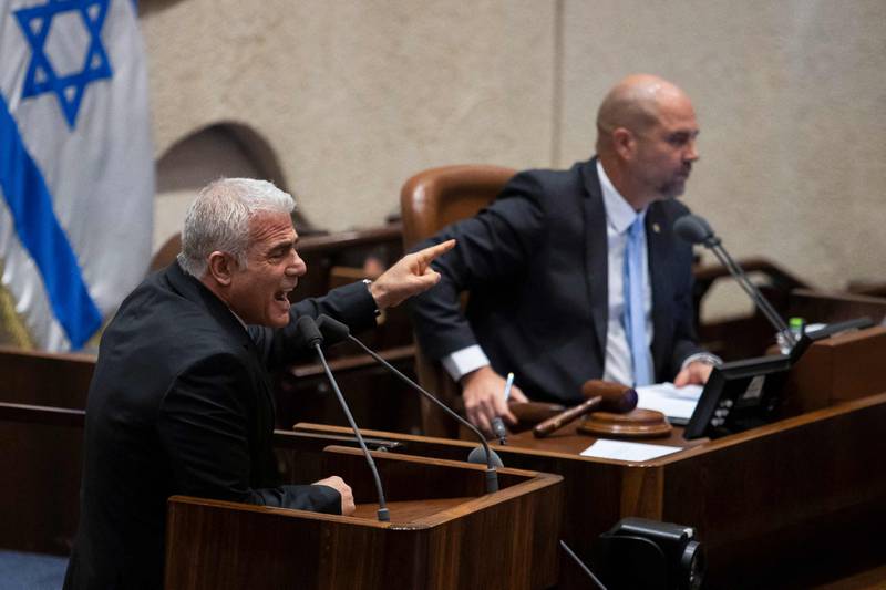 Opposition leader and former prime minister Yair Lapid, left, speaks during a reading on controversial government judicial reforms. AFP