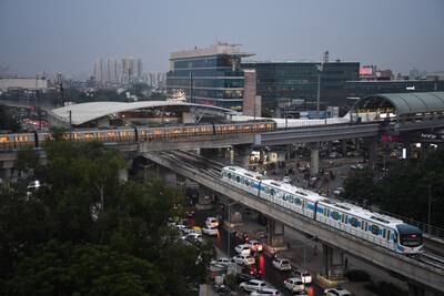 A Delhi Metro train and Gurugram rapid train at a station in New Delhi. The Haryana government changed the name of the state's biggest city in 2016 from Gurgaon to Gurugram, said to be a historical name 