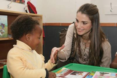 CAPE TOWN, SOUTH AFRICA - APRIL 03:  In this photo released by the Jordanian Royal Palace, Her Majesty Queen Rania of Jordan, a member of the UNICEF Global Leadership Initiative for Children, talks to a child during her visit to the Vukile Tshwete Enrichment Center in the city of Cape Town, South Africa April 03, 2006. (Photo by Jordanian Royal Court via Getty Images) 