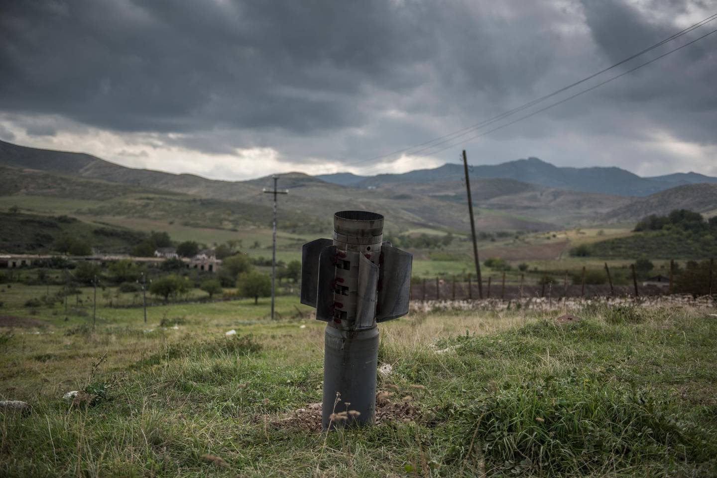 In this image released by World Press Photo, Thursday April 15, 2021, by Valery Melnikov, Sputnik, part of a series titled Paradise Lost, which won the first prize in the General News Stories category, shows A rocket remaining after the shelling of the city of Martuni (Khojavend), Nagorno-Karabakh, lies in a field, on 10 November, the day the peace agreement between Armenia and Azerbaijan came into effect. (Valery Melnikov, Sputnik, World Press Photo via AP)
