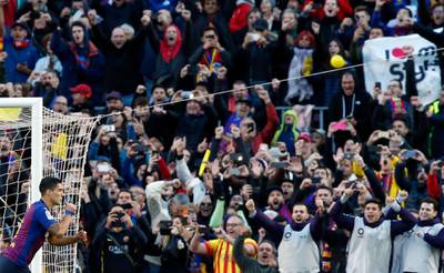 Barcelona forward Luis Suarez celebrates after scoring his side's second goal during the Spanish La Liga soccer match between FC Barcelona and Real Madrid at the Camp Nou stadium in Barcelona, Spain. AP Photo