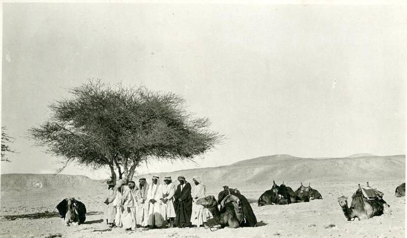 Harry St John Philby and his companions at Wadi Al Shajara, where they stopped for a prayer on his 1917 trip to Riyadh. He included the photo in his 1922 book, The Heart of Arabia