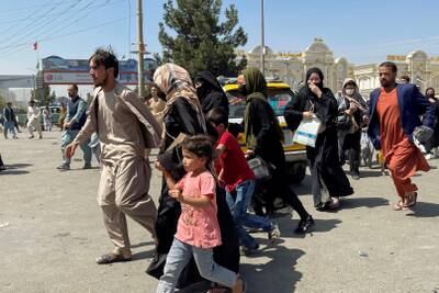 People try to enter Hamid Karzai International Airport in Kabul, Afghanistan.