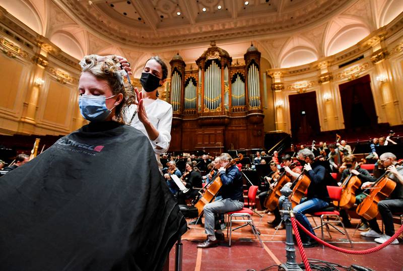 A customer gets a haircut in a concert hall as museums and concert halls protest against government rules allowing gyms and hairdressers to re-open while they have to stay shut due to Covid-19 restrictions in Amsterdam, Netherlands, on January 19. Reuters