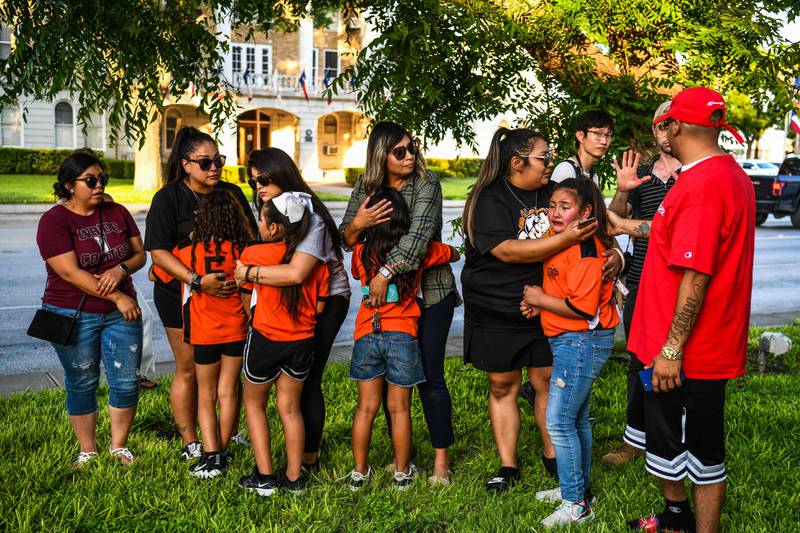 Football teammates of Tess Mata, who died in the Uvalde shooting in the US, with their mothers. AFP
