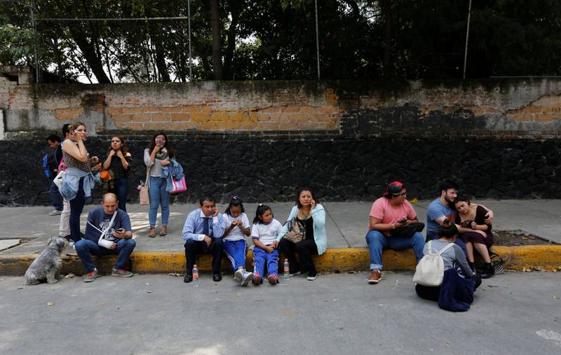 People and children are seen on a street after an earthquake in Mexico City. Claudia Daut / Reuters
