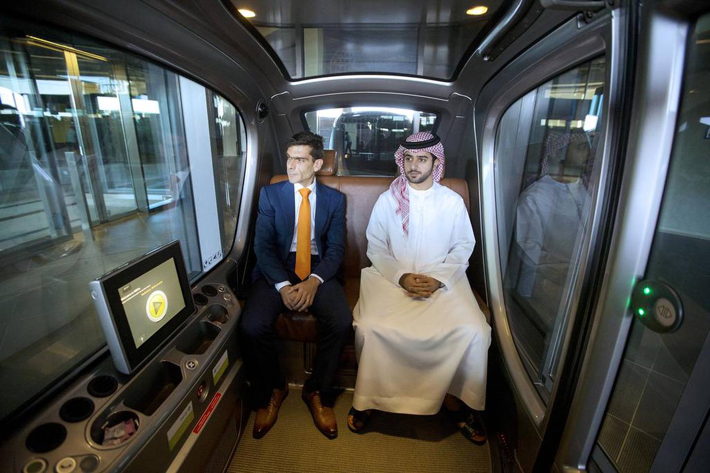 Karim Karam, left, a professor of engineering systems management, and Hamad Al Raqbani, a research engineer, in a driverless vehicle at the Masdar Institute in Abu Dhabi. Christopher Pike / The National