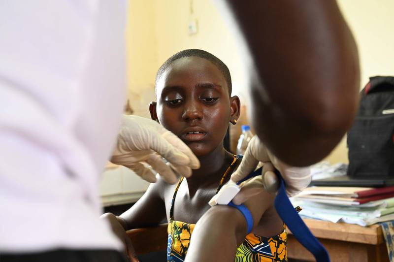 Prisca Dali,14, who was diagnosed with Human African Trypanosomiasis after being ill for 4 years, has her blood drawn during an Human African Trypanosomiasis, also known as sleeping sickness, screening in the village of Paanenefla near Sinfra, Ivory Coast on October 11, 2019. - Sleeping sickness, a parasitic infection that once caused thousands of deaths annually in sub-Saharan Africa, is nearing elimination, but scientists warn affected countries must not drop their guard.The disease, transmitted to humans by the Tsetse fly was once the bane of more than 30 countries who suffered devastating epidemics over the past century. (Photo by ISSOUF SANOGO / AFP)