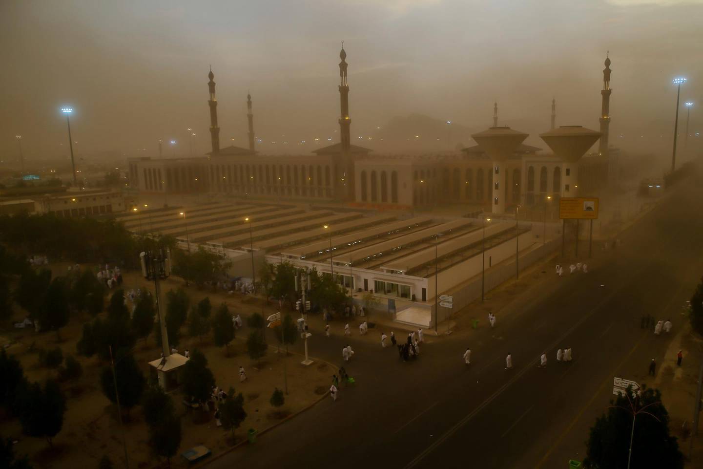A sand storm engulfs Muslim pilgrims as they arrive at Namirah Mosque on Arafat Mountain, during the annual hajj pilgrimage, outside the holy city of Mecca, Saudi Arabia, Sunday, Aug. 19, 2018. More than 2 million Muslims have begun the annual hajj pilgrimage, representing one of the five pillars of Islam and is required of all able-bodied Muslims once in their life. (AP Photo/Dar Yasin)