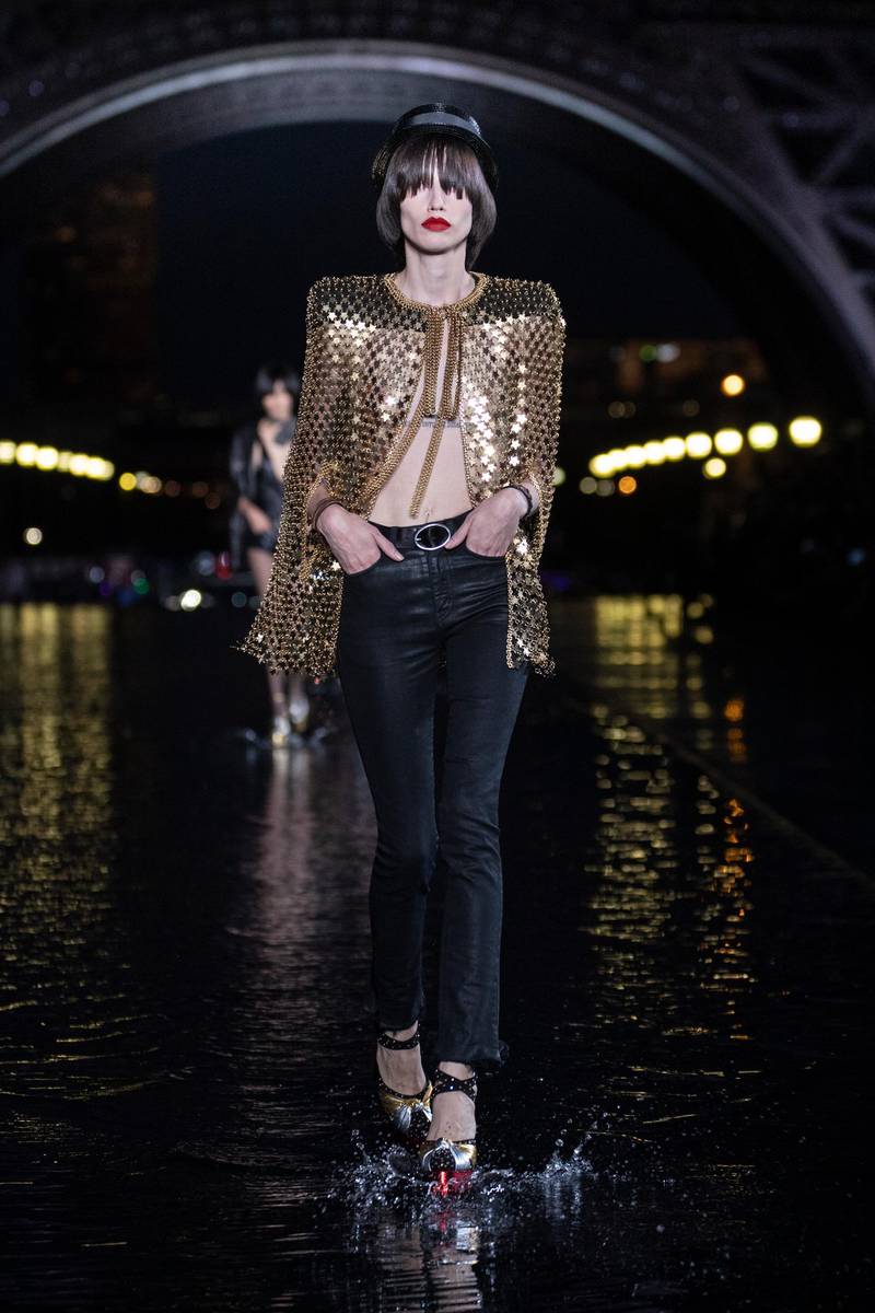 <p>Gleaming gold mesh is carved into a box-shouldered cape at Saint Laurent.</p>
