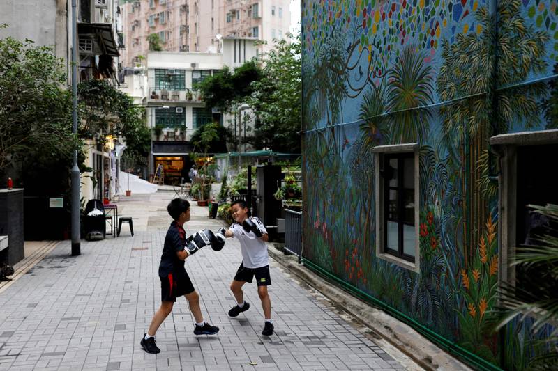 Children practise boxing on a street in Hong Kong ahead of the 25th anniversary of Hong Kong's handover to China from Britain. Reuters