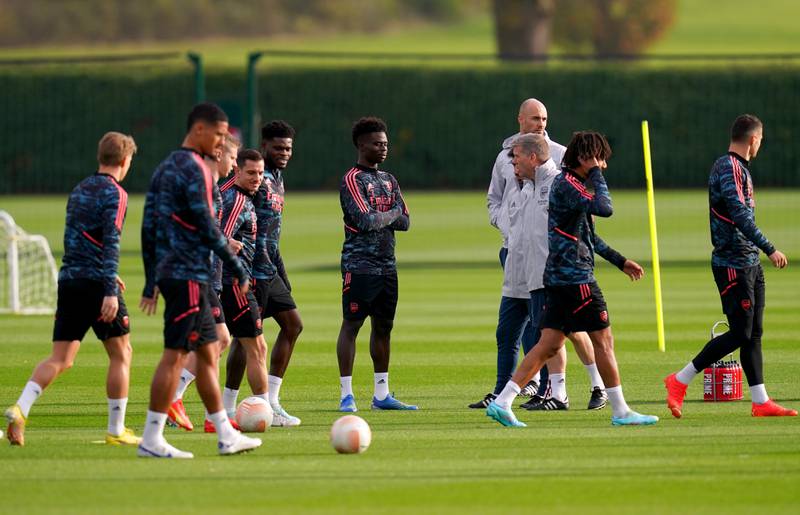 Arsenal players take part in training. PA