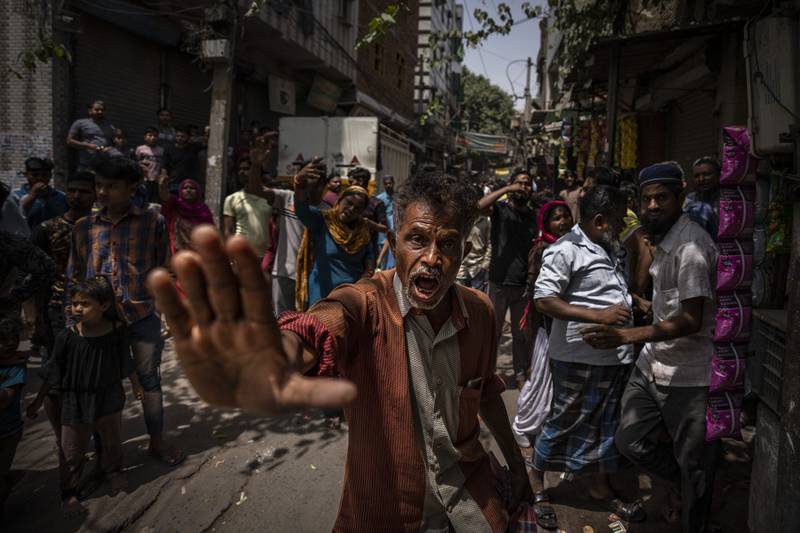 An agitated Muslim resident asks media to leave after alleging them of distorting facts during the demolition of Muslim-owned shops in New Delhi's north-west Jahangirpuri neighbourhood.  AP