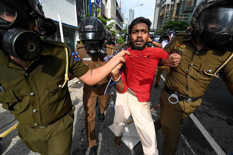 Police detain this student in Colombo. AFP