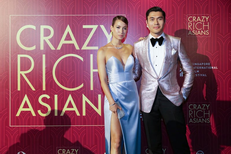Actor Henry Golding and his wife Liv Lo pose as they arrive for the red carpet. Don Wong / AP photo