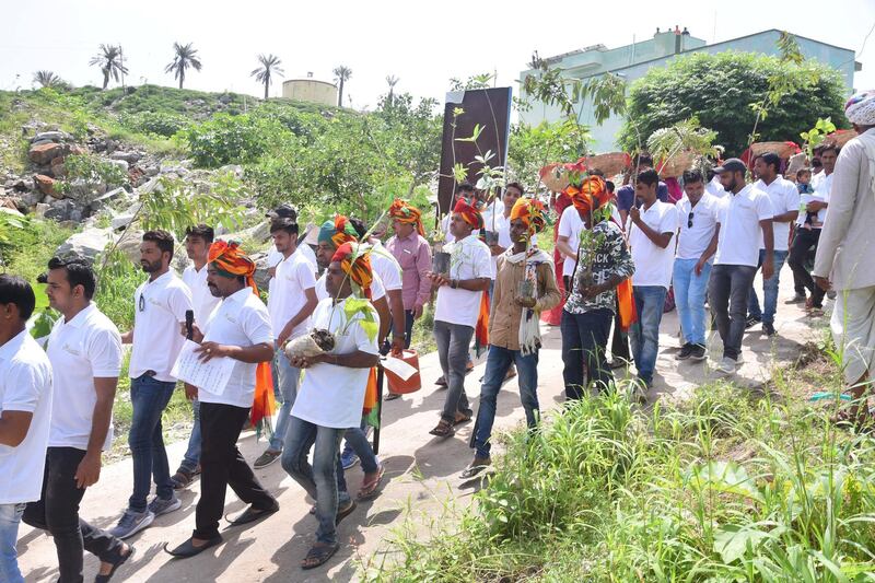 GC- Villagers plant trees to celebrate birth of girl child in Piplantri village in the desert state of Rajasthan. 
Shyam Sunder Paliwal (moustached man in white clothes and turban) seen with villagers as they celebrate 'Raksha Bandhan' by tying rakhi to plants. 
Picture credit- Prem Shankar