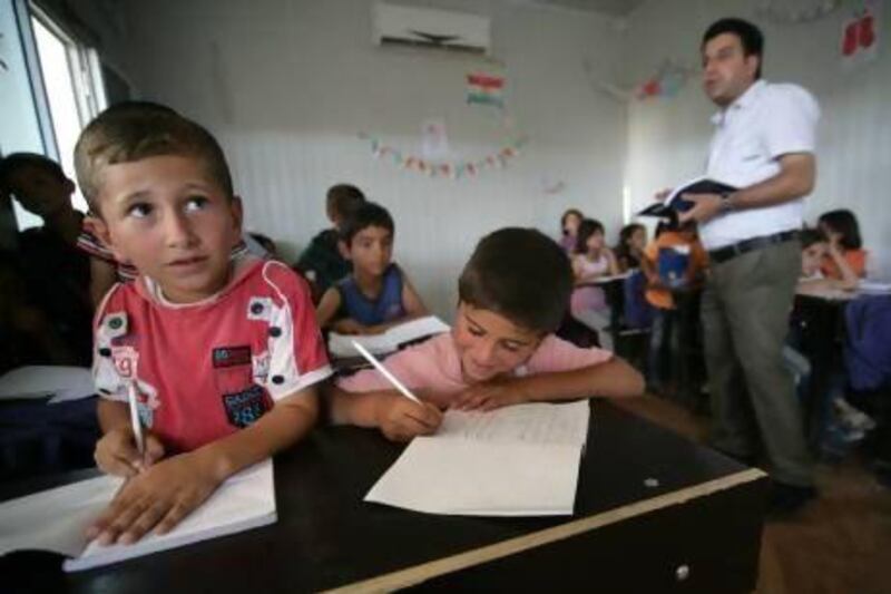 Children attend a class at the Domiz refugee camp, 20km southeast of the northern Iraqi city of Dohuk, which houses Syrian-Kurd refugees.