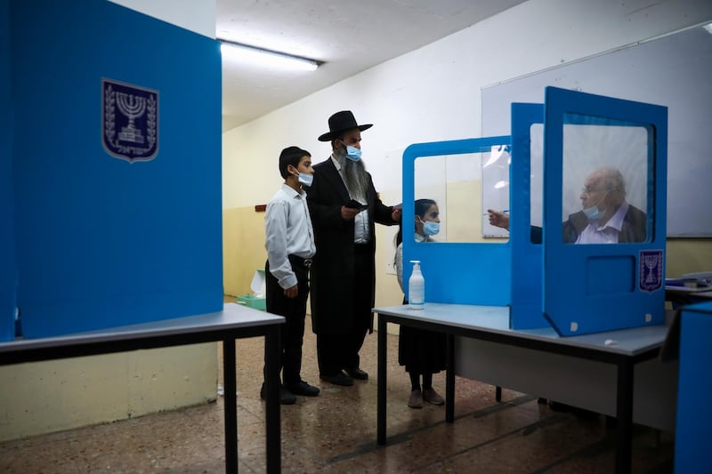 An ultra-Orthodox Jewish man arrives to vote in Israel's parliamentary election, at a polling station in Bnei Brak. AP
