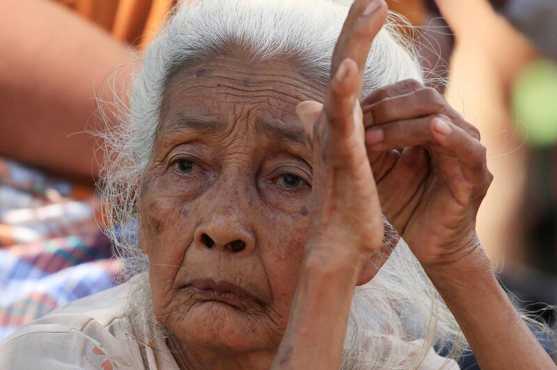 A elderly woman sits at a refugee camp after an earthquake hit Sigar Penjalin village in North Lombok, Indonesia. Reuters
