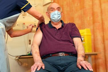 Brian Pinker, 82, receives the Oxford University/AstraZeneca coronavirus vaccine from nurse Sam Foster at the Churchill Hospital in Oxford, England. AP