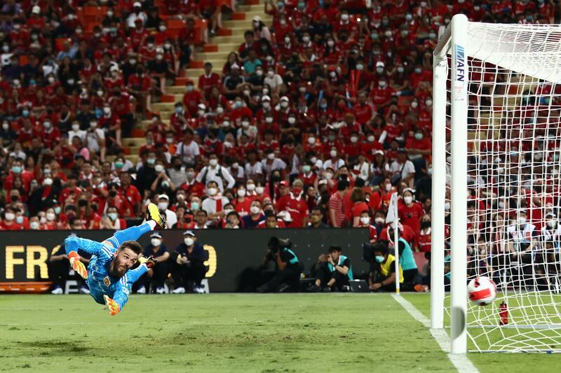 Manchester United goalkeeper David de Gea dives to try to save a shot. AFP