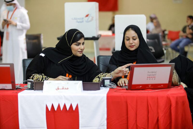 Bahraini poll clerks prepare to receive voters at a polling station on the island of Muharraq, north of the capital Manama, during parliamentary elections, on November 12, 2022.  - More than 330 candidates, including a record 73 women, are competing to join the 40-seat council of representatives, the lower house of parliament that advises King Hamad bin Isa Al-Khalifa, who has ruled since his father died in March 1999.  (Photo by AFP)