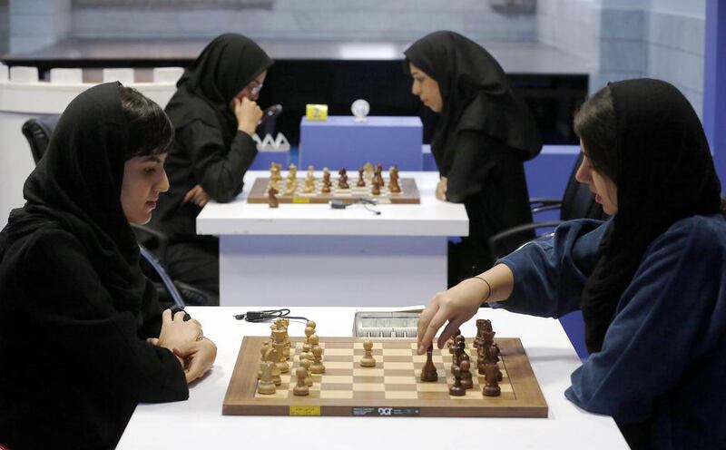 Iranian chess players Mitra Hejazipour, left, and Sara Khademalsharieh play at the Chess Federation in the capital Tehran on October 10, 2016. Atta Kenare / AFP