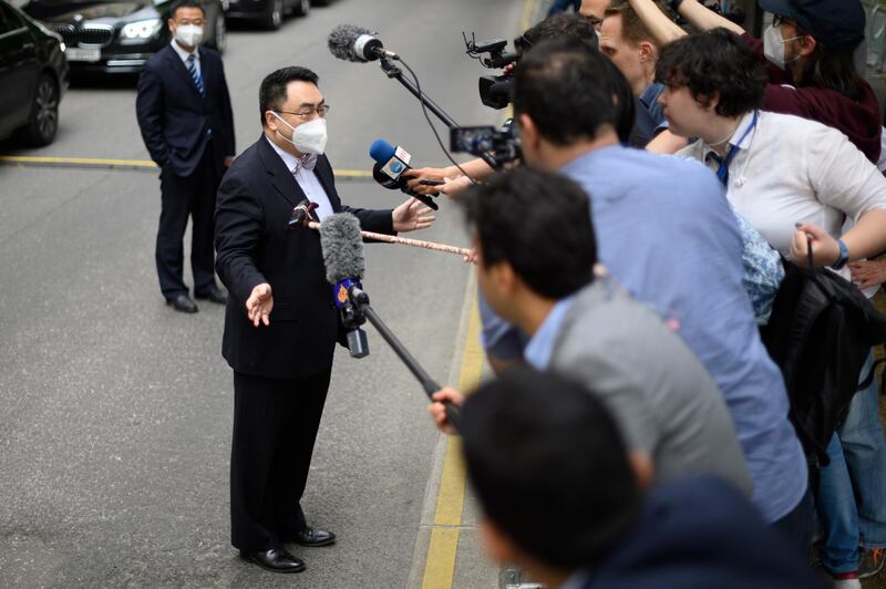 Qun Wang addresses the media in Vienna. EPA