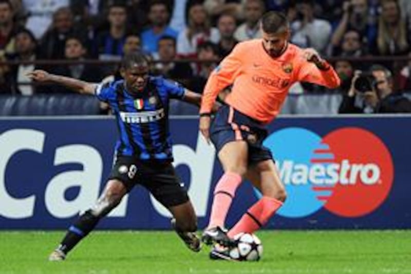 Inter Milan's Cameroon forward Samuel Eto'o, left, fights for the ball with his former teammate, Barcelona's Gerard Pique, at the San Siro.