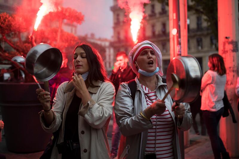 Restaurant owners clang spoons and dishes at a demonstration against restaurant closures in Marseille, southern France. AP Photo