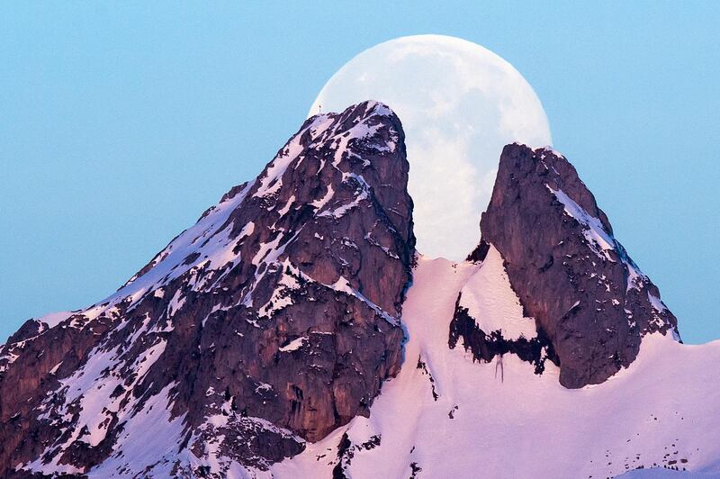 The moon sets behind the Les Jumelles Mountains in Plambuit, Switzerland. AP Photo