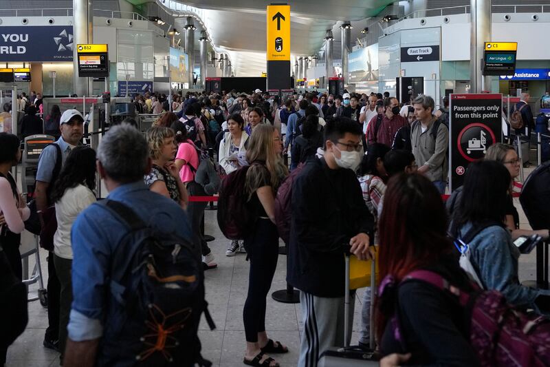 Passengers queue for security checks at London Heathrow, the UK's main international airport. AP