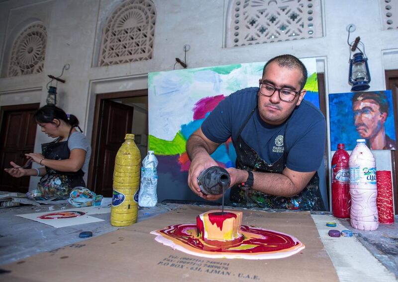 Abdullah Lutfi, who has autism, paints at Mawaheb, an art studio in Dubai’s Al Fadi neighbourhood. Victor Besa for The National