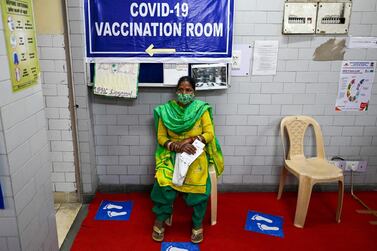 A woman waits to get a Covid-19 vaccine as India recorded more than 50,000 new coronavirus cases for the first time since November as a new wave of infections takes hold. AFP.