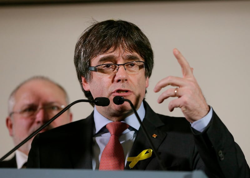 FILE - In this Thursday, Dec. 21, 2017 file photo, ousted Catalan leader Carles Puigdemont speaks during a press conference at the Square Meeting Center in Brussels. Cataloniaâ€™s main separatist parties said Wednesday Jan. 10, 2018 they have agreed to re-elect fugitive Carles Puigdemont as president of the region later this month, although how to make that legally possible is still up in the air. (AP Photo/Virginia Mayo, File)