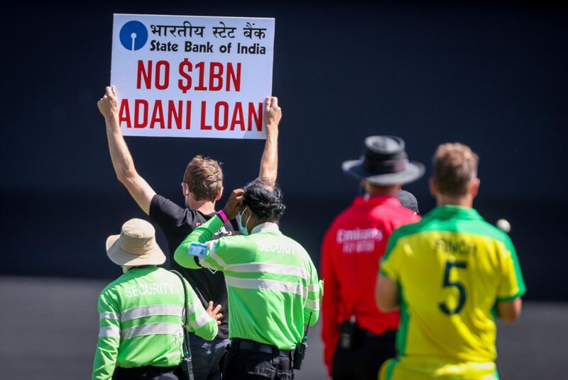 A protester is escorted off the Sydney Cricket Ground. AFP