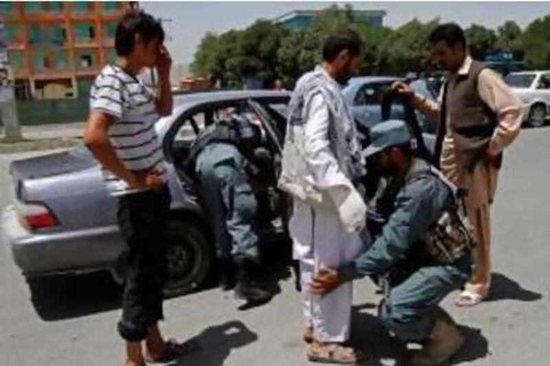 Afghan police officers check vehicles and passengers as security measures are tightened ahead of the International Conference on Afghanistan in Kabul, Afghanistan, Monday, July 19, 2010. Some 40 foreign ministers are expected to attend the conference. (AP Photo/Rahmat Gul) *** Local Caption ***  DV102_Afghanistan_.jpg