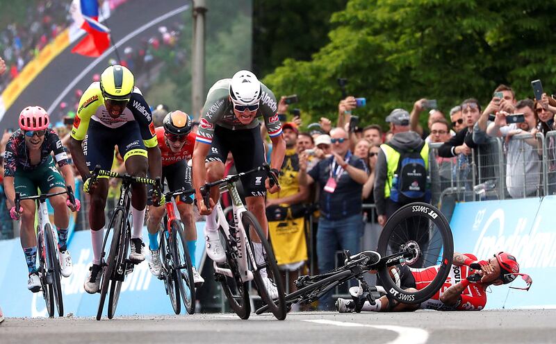Alpecin-Fenix rider Mathieu Van Der Poel sprints to victory on Stage One of the 2022 Giro d'Italia as Lotto Soudal's Caleb Ewan falls. Reuters