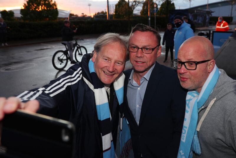 Manchester City fans celebrate with former player Paul Dickov at the Etihad Stadium. PA