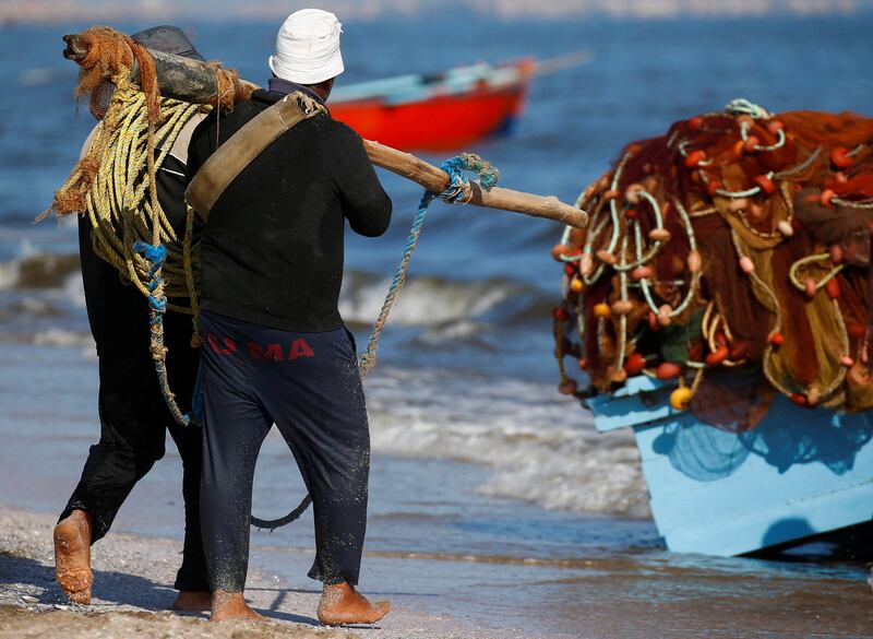 Fishermen pull up their nets.