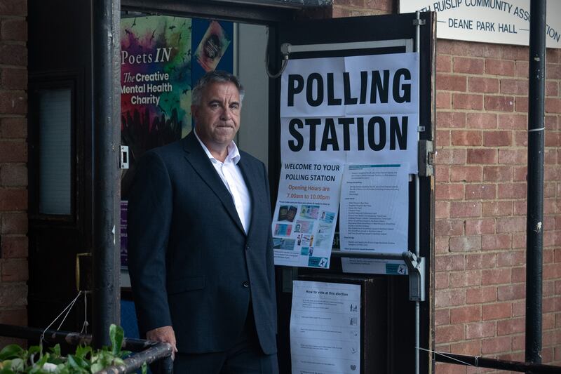 Mr Tuckwell leaves after casting his vote in Uxbridge. Getty