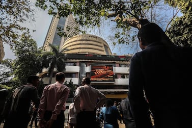 People watch a screen displaying the budget news near the entrance of the Bombay Stock Exchange in Mumbai. EPA