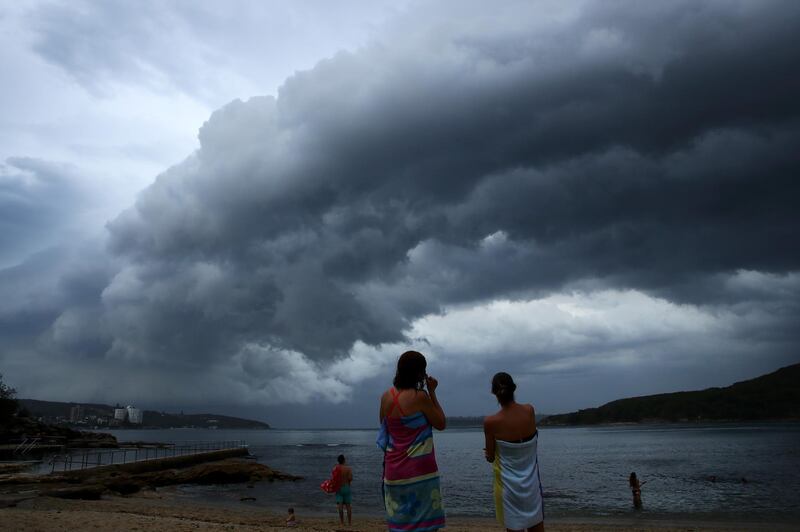 People watch a storm front cross Sydney Harbour at Fairlight Beach in Sydney, Australia. Heavy wind, rain and severe hailstorms are expected throughout eastern New South Wales.  Cameron Spencer / Getty Images