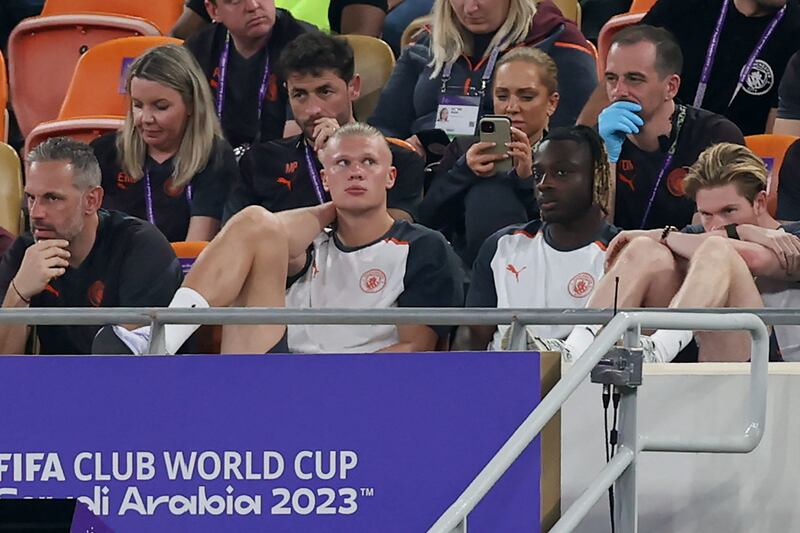 Manchester City's Erling Haaland, second left, watches the game from the bench. AFP