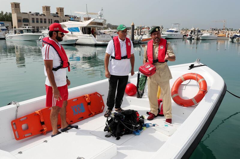 DUBAI , UNITED ARAB EMIRATES , November 26  – 2018 :- Lt. Colonel Ali Abdullah Al Qaseeb Al Naqbi , Head of the Maritime Rescue ( right ) explaining about the rescue equipment at the Fishermen village in Jumeirah in Dubai. ( Pawan Singh / The National ) For News. Story by Salam