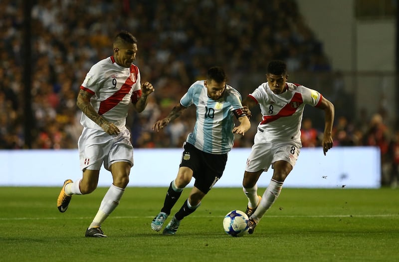 Lionel Messi takes on Paolo Guerrero and Wilder Cartagena. Agustin Marcarian / Reuters