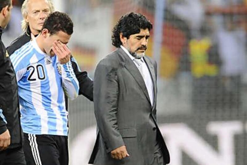 Diego Maradona, the Argentina coach, exits the pitch after his side's quarter-final defeat to Germany yesterday. The famed Argentine flair was stifled by the European side in the one-sided match.