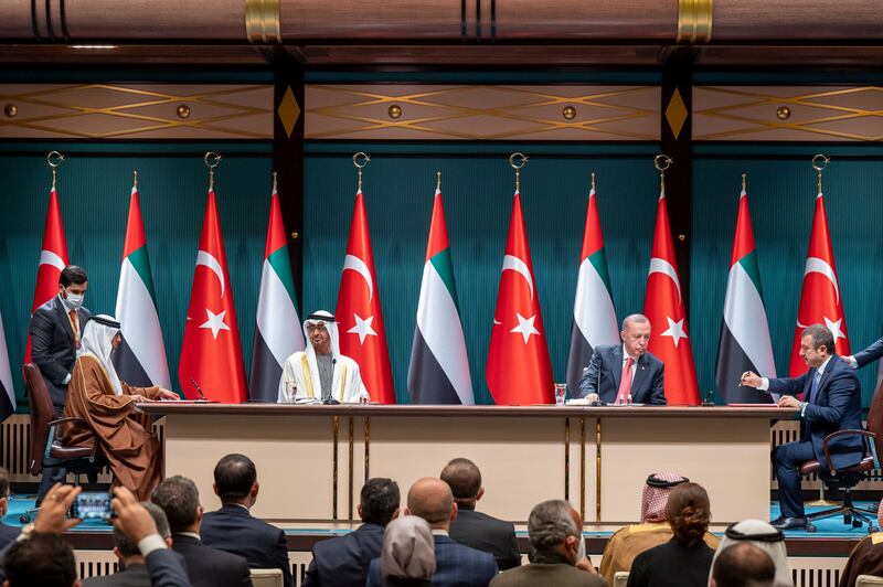 Sheikh Mohamed and Mr Erdogan watch as an agreement is signed by Mr Al Mazrouei and Turkish Central Bank President Sehab Kavcioglu. Abdulla Al Neyadi / Ministry of Presidential Affairs