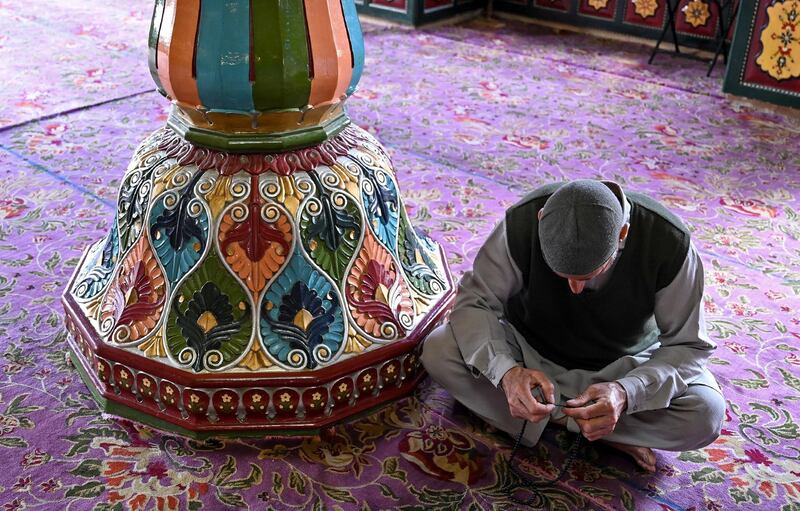 A Kashmiri Muslim looks on holding prayer beads at the Sheikh Abdul Qadir Geelani Shrine during the holy month of Ramadan in Srinagar.  AFP